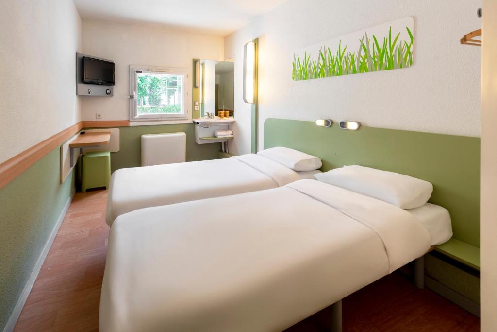 Un ou plusieurs lits dans un hébergement de l'établissement B&B HOTEL Toulouse Cité de l'Espace Hurel