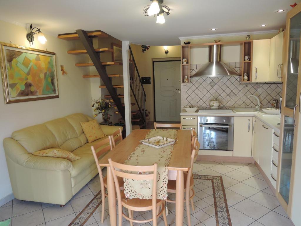 a kitchen and living room with a table and a couch at Apartment Mare Giardini Naxos in Giardini Naxos