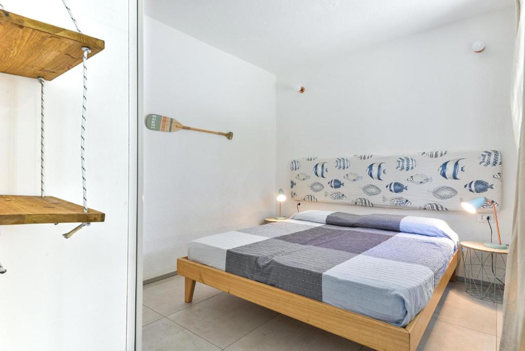 a bedroom with a bed with blue patterns on the wall at Villa Fantagali apt 501 in Marina di Campo
