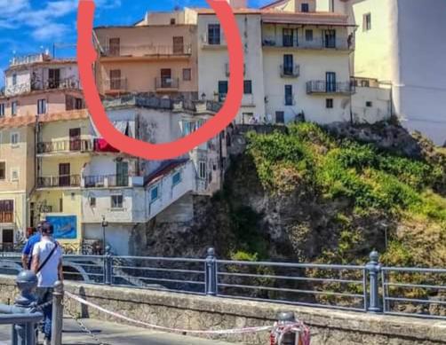 a large red ring is hanging over a city at Casa di Maria in Diamante