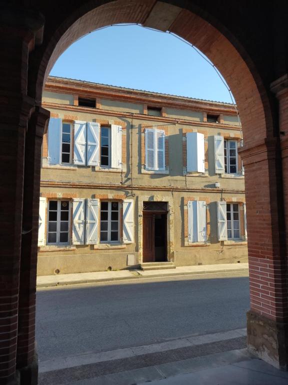 an archway view of an old building from a street at Artbnb in Lézat-sur-Lèze