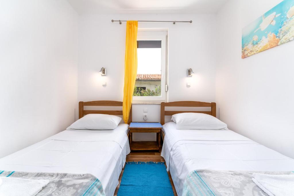 Postel nebo postele na pokoji v ubytování Apartmani RUBESSA