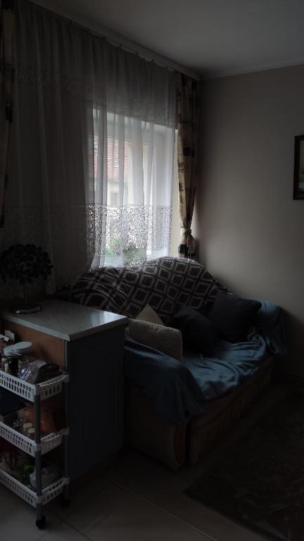 a small bedroom with a bed and a window at Apartament Karłowicza in Gdańsk