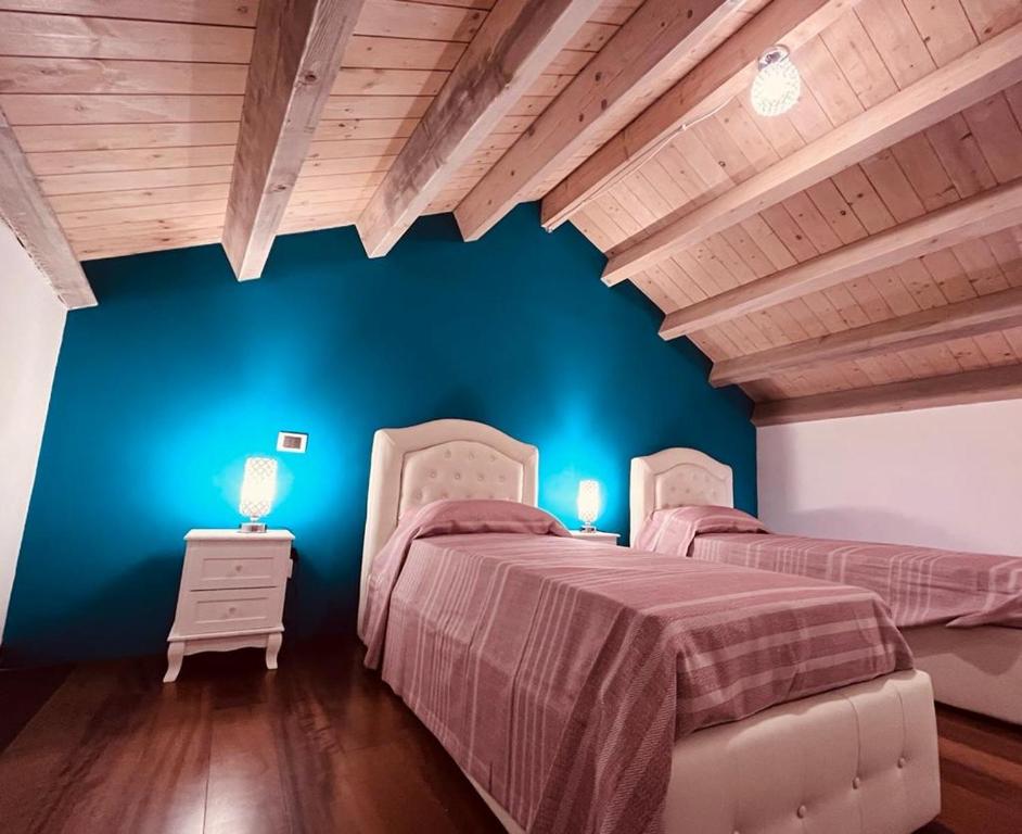 Säng eller sängar i ett rum på APPARTAMENTO SUITE SARDINIA HOLIDAY