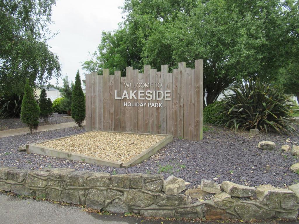 a sign for a park with a sign for lake pesticide at Chichester Lakeside Self-Catering Holiday Home in Chichester