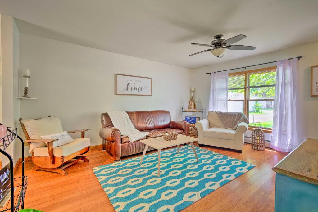a living room with a couch and chairs and a rug at Cozy Auburn Retreat with Hot Tub - Walk to Lake in Auburn
