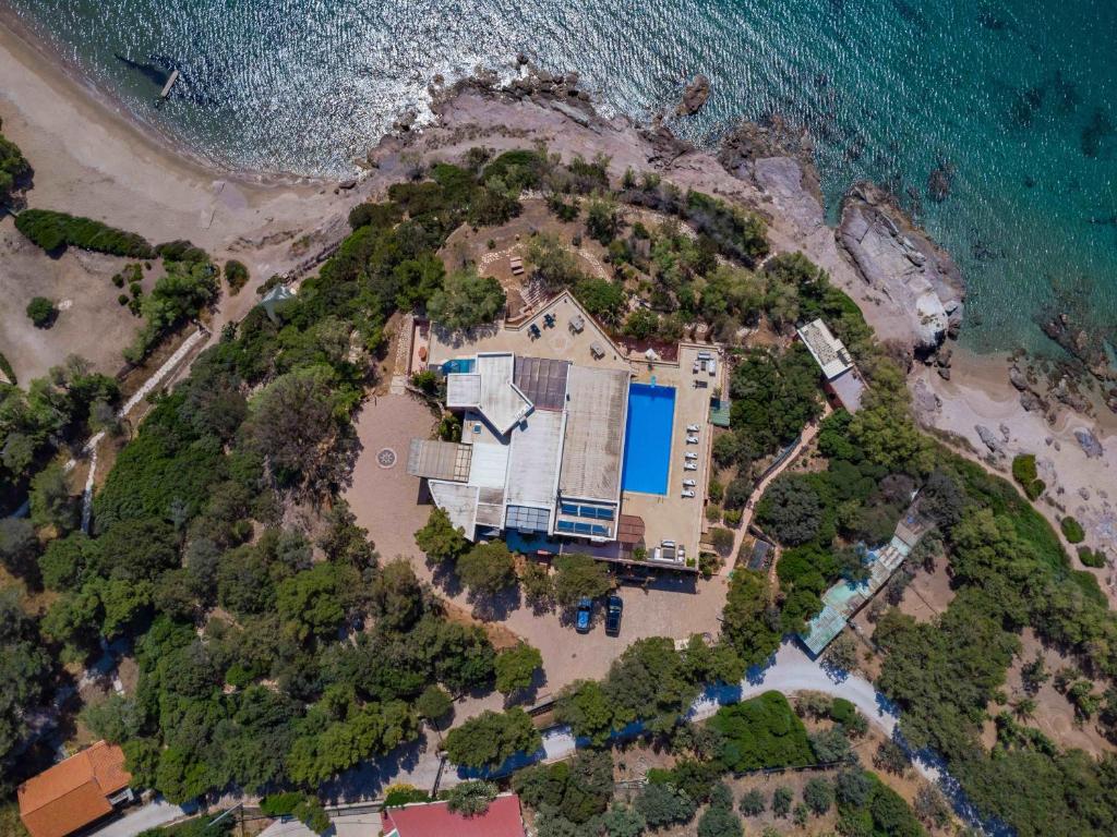 an aerial view of a house on a beach at Black Diamond Beachfront Pool Villa Pasithea in Sounio, Athens in Sounio