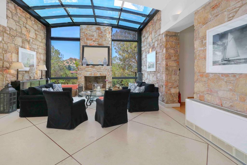 A seating area at Black Diamond Beachfront Pool Villa Pasithea in Sounio, Athens
