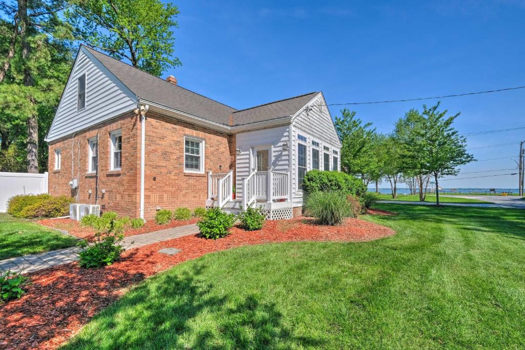 a brick house with a lawn in front of it at Waterfront North Beach Home about 2 Mi to Beach! in Deale