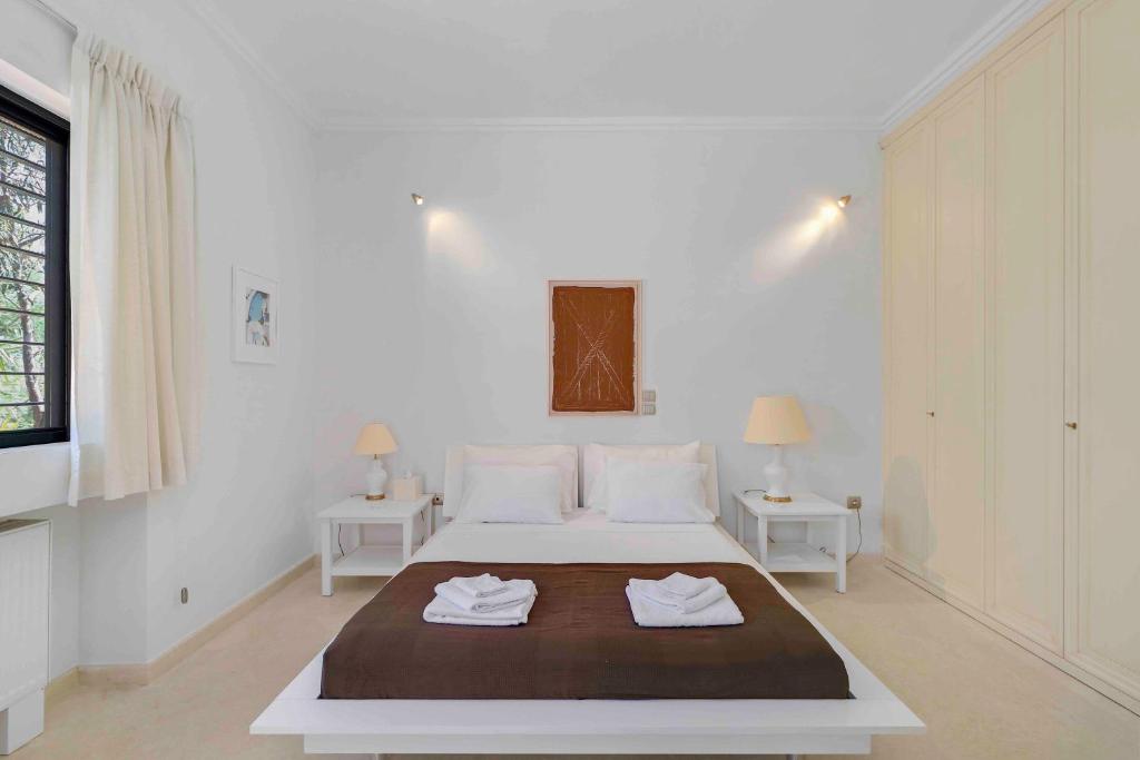 A bed or beds in a room at Black Diamond Beachfront Pool Villa Pasithea in Sounio, Athens
