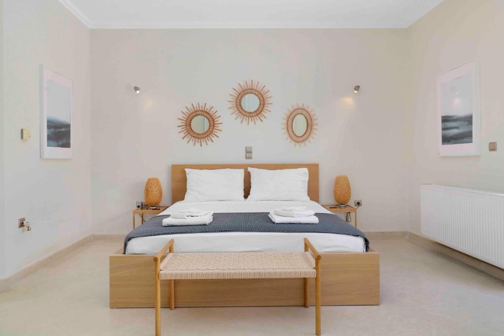 A bed or beds in a room at Black Diamond Beachfront Pool Villa Pasithea in Sounio, Athens
