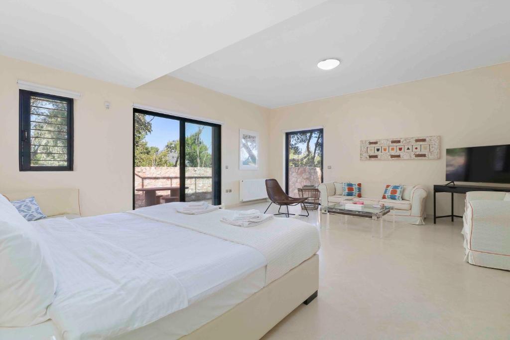 A television and/or entertainment centre at Black Diamond Beachfront Pool Villa Pasithea in Sounio, Athens