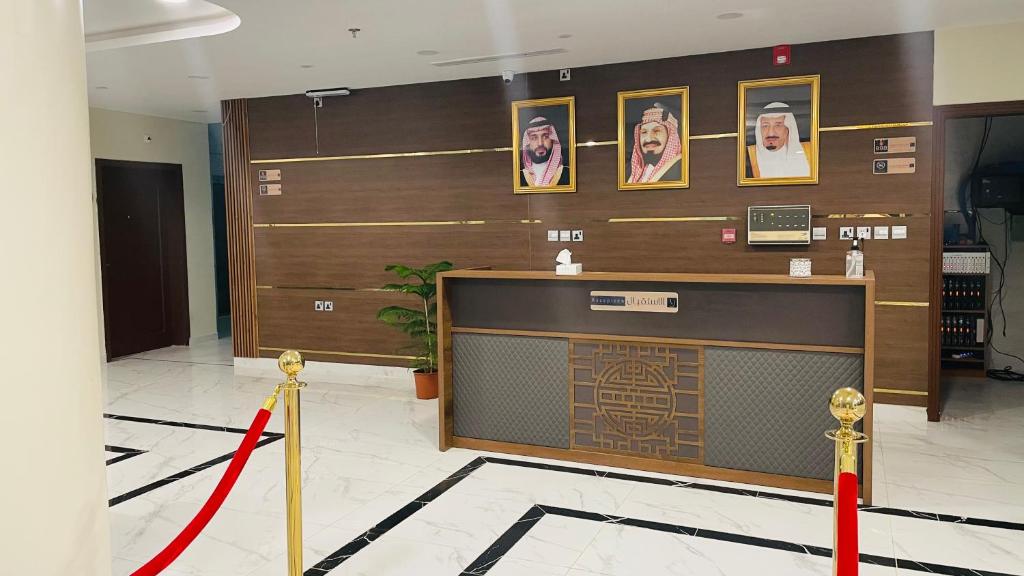 a lobby with a reception desk with a red ribbon at فندق فخر ينبع 5 in Yanbu