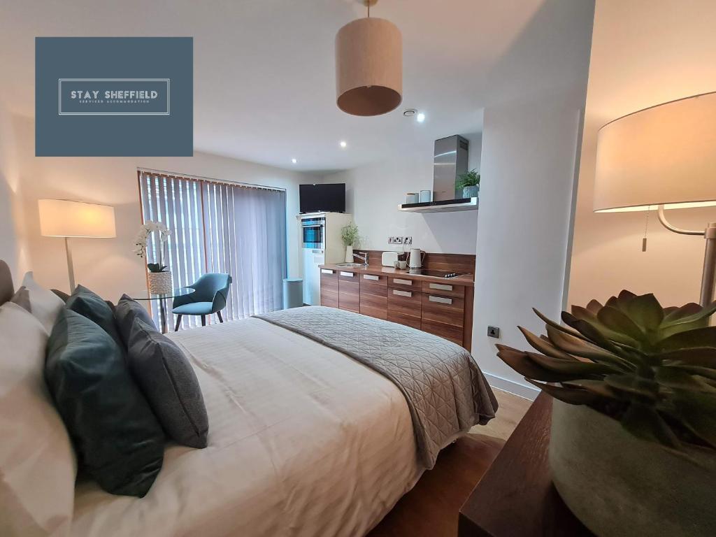 a bedroom with a bed and a desk and a chair at Sheffield City Centre Studio in Sheffield