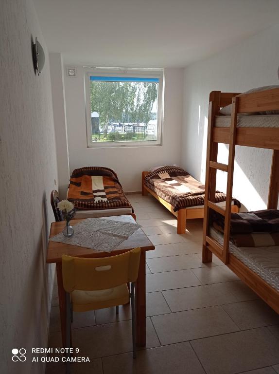 a room with two bunk beds and a table at LKS Charzykowy 4 in Charzykowy