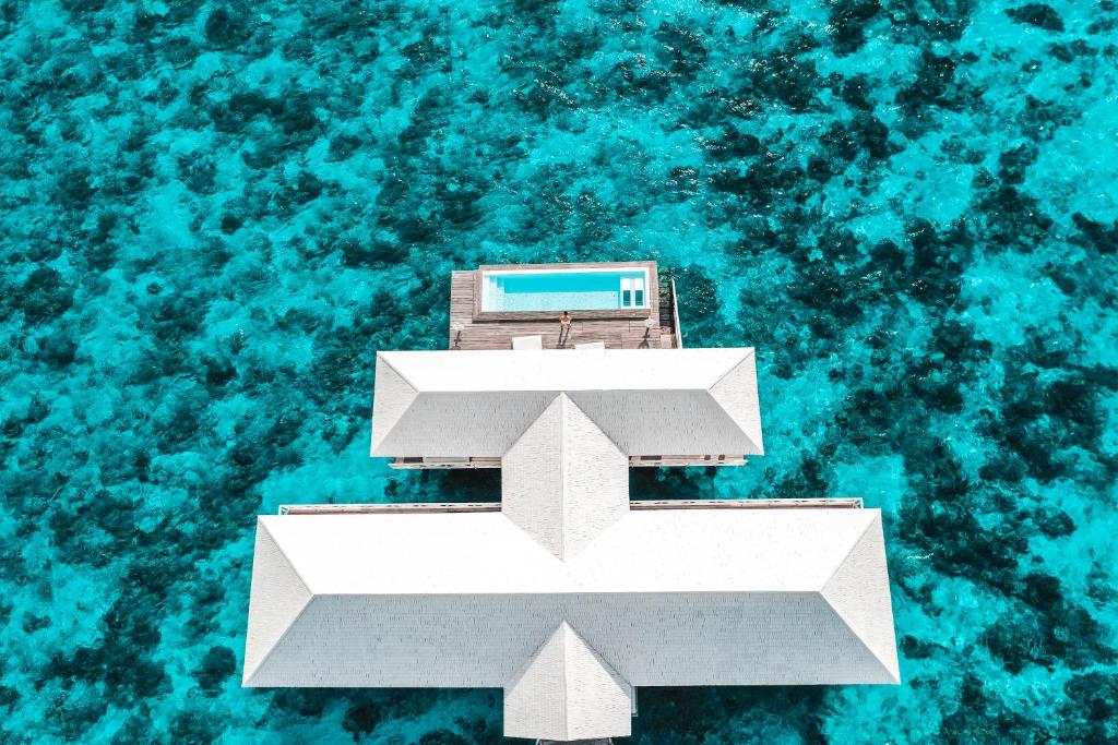an aerial view of a building in the water at Diamonds Thudufushi Maldives Resort & Spa in Thundufushi