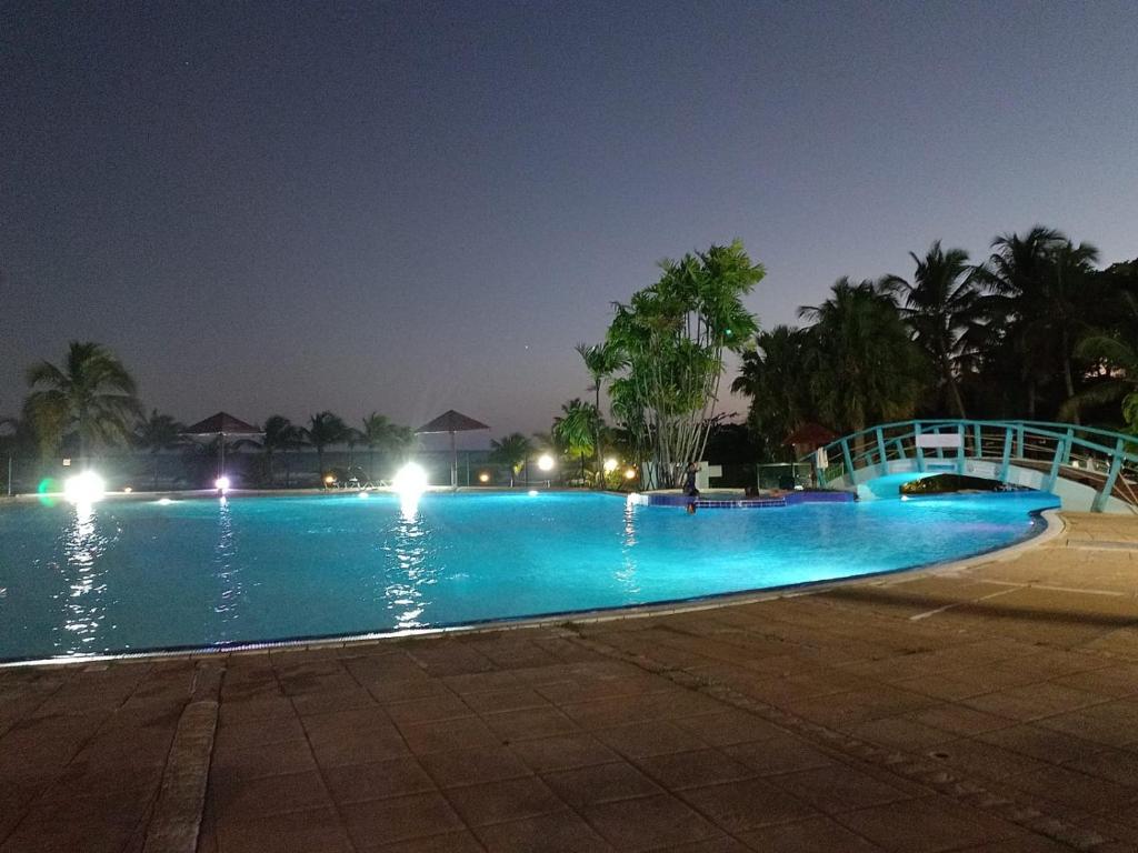 a large swimming pool at night with lights at STUDIO 1015 in Sainte-Anne