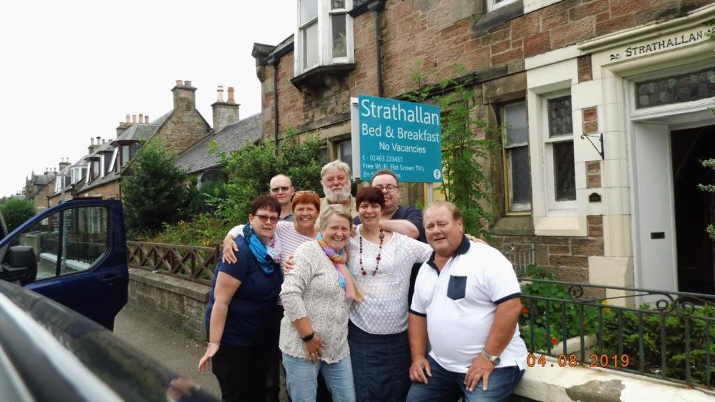 a group of people standing in front of a building at Strathallan B&B in Inverness