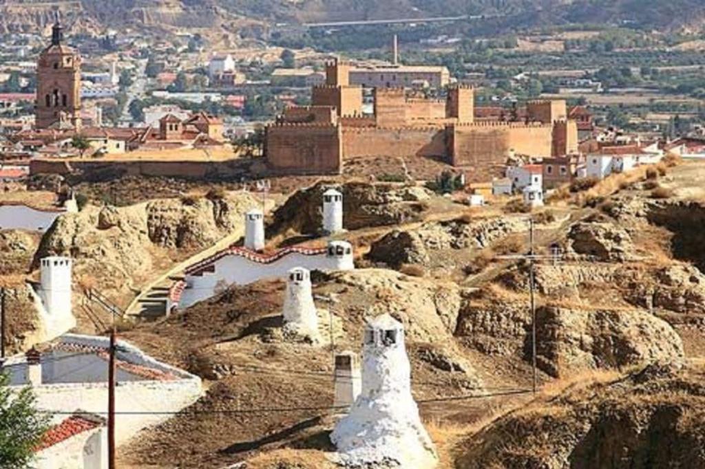 a view of a city on a mountain with a town at Cueva en Guadix in Guadix