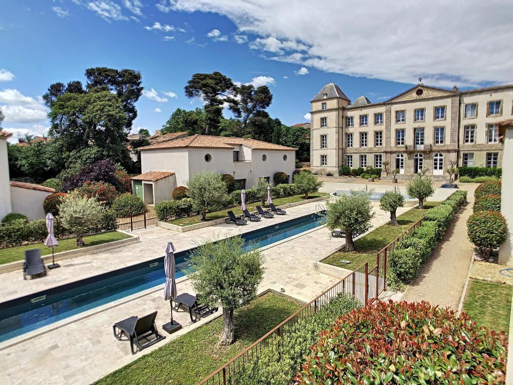 an aerial view of a building with a swimming pool at **LOVELY APARTMENT IN THE CASTLE OF LA REDORTE** in La Redorte