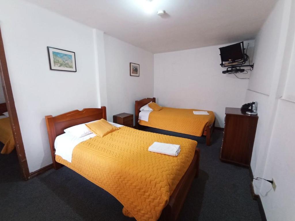 Postel nebo postele na pokoji v ubytování Hotel 9 de Octubre