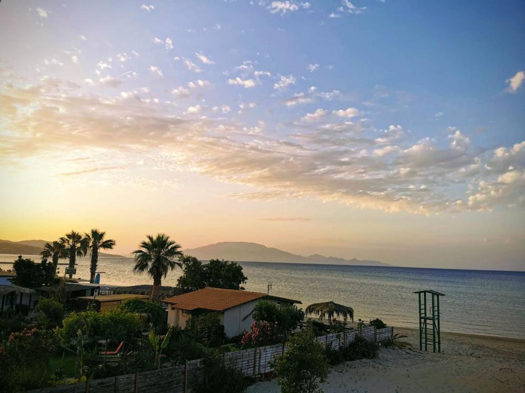 vistas a una playa con palmeras y al océano en Anatolikos Rooms en Alykes