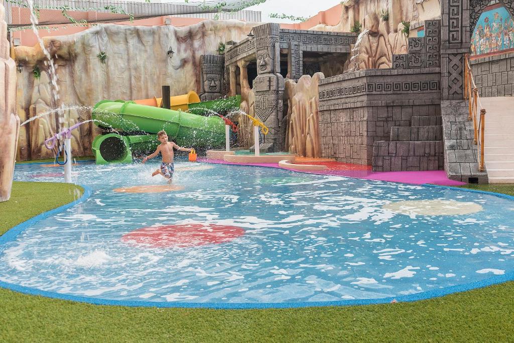 a young boy in a pool in a water park at Grand Fiesta Americana Coral Beach Cancun - All Inclusive in Cancún