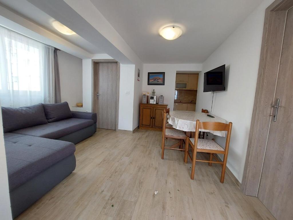 a living room with a couch and a table at Makarska Best Buy Apartments in Makarska