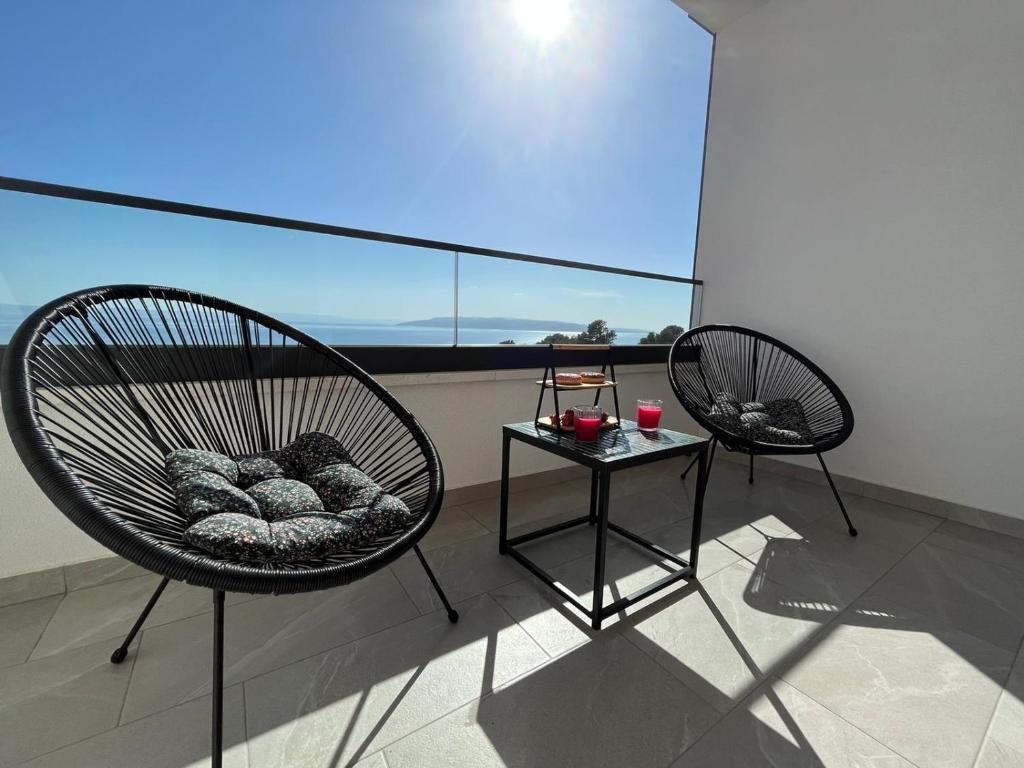 2 sillas y mesa en un balcón con vistas en Apartman J&M en Makarska