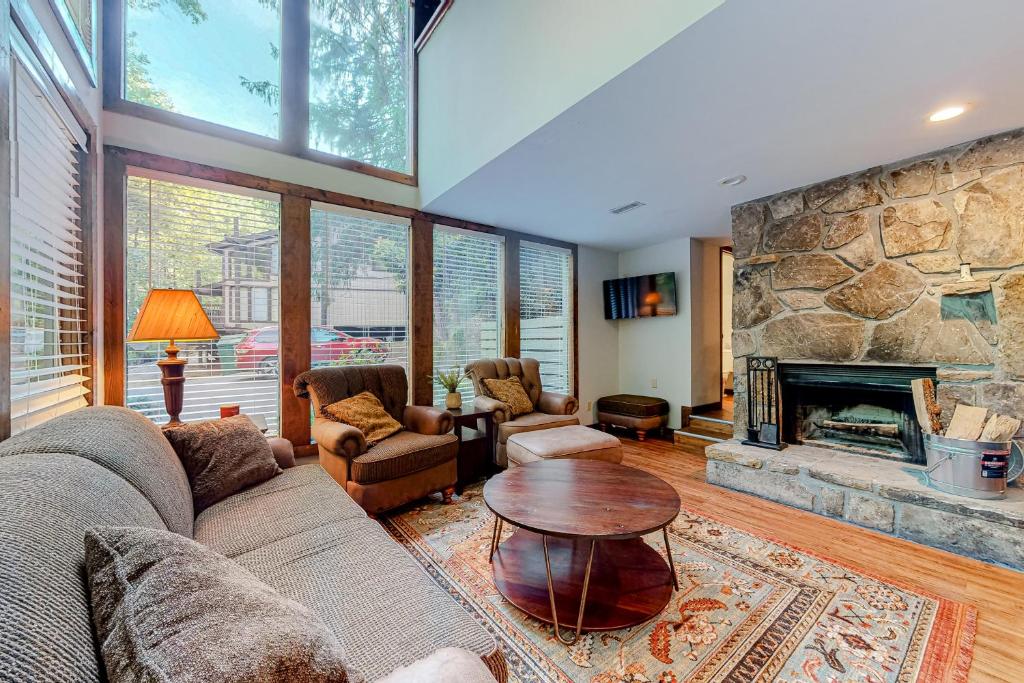 a living room with a couch and a stone fireplace at Buckberry Creek Unit 1 in Gatlinburg