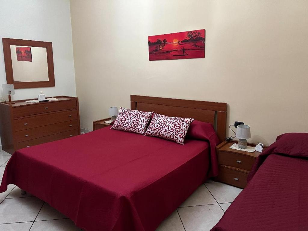 - une chambre avec un lit doté d'un couvre-lit rouge dans l'établissement Annalisa house 134, à Naples