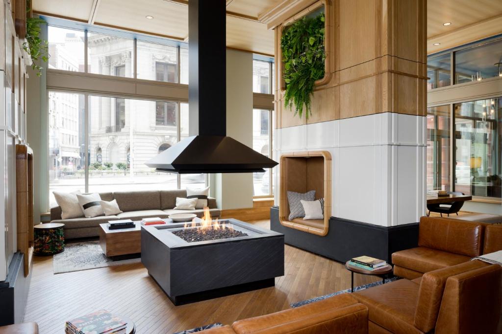a living room filled with furniture and a large window at Kimpton Schofield Hotel, an IHG Hotel in Cleveland