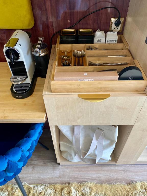 a wooden drawer with a hair dryer and a printer at Hausboot mit Traumlage in Lübeck-Travemünde in Rönnau