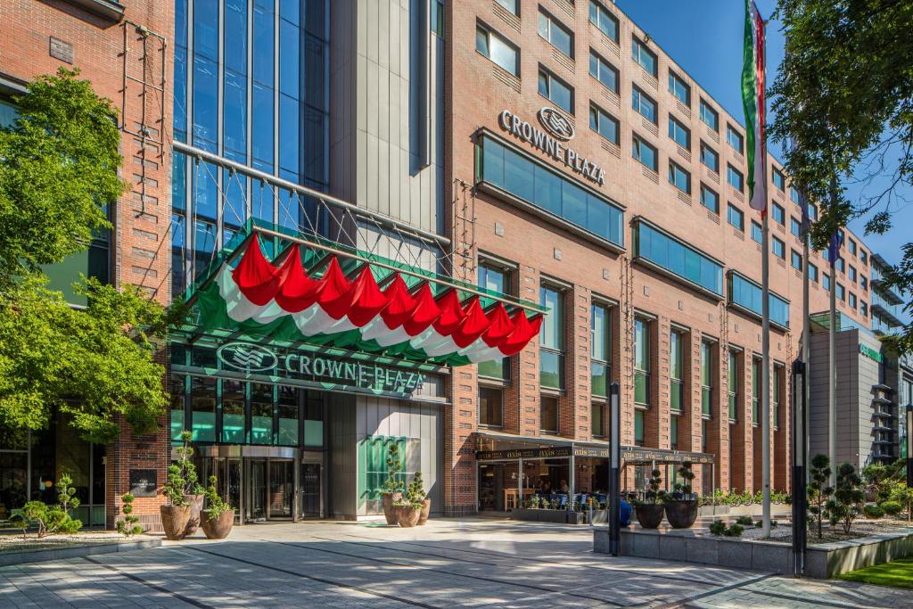 a store front of a building with a red awning at Crowne Plaza Budapest, an IHG Hotel in Budapest