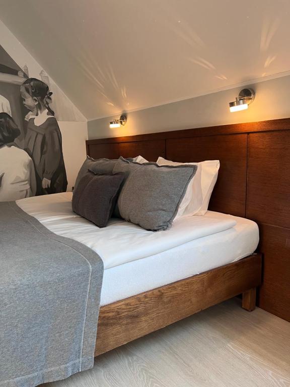 a bedroom with a bed with white sheets and pillows at Kamienica 22 Old Town in Gdańsk