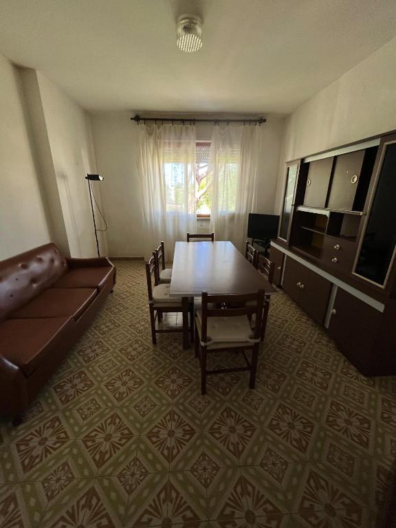 salon ze stołem i kanapą w obiekcie Casa Palma - 300mt dal Mare w mieście Marina di Massa