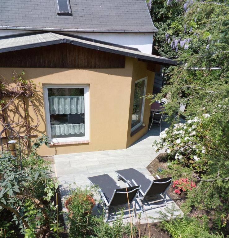 a patio with chairs and a table in front of a house at Ferienhaus-der-Villa-Elsa in Dresden