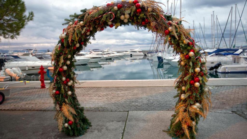 a christmas wreath on a marina with boats at Villa Beller New in Ičići