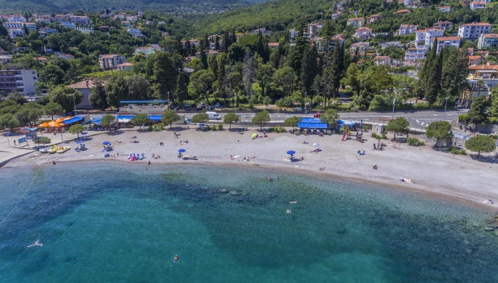 an aerial view of a beach with people in the water at Villa Beller New in Ičići