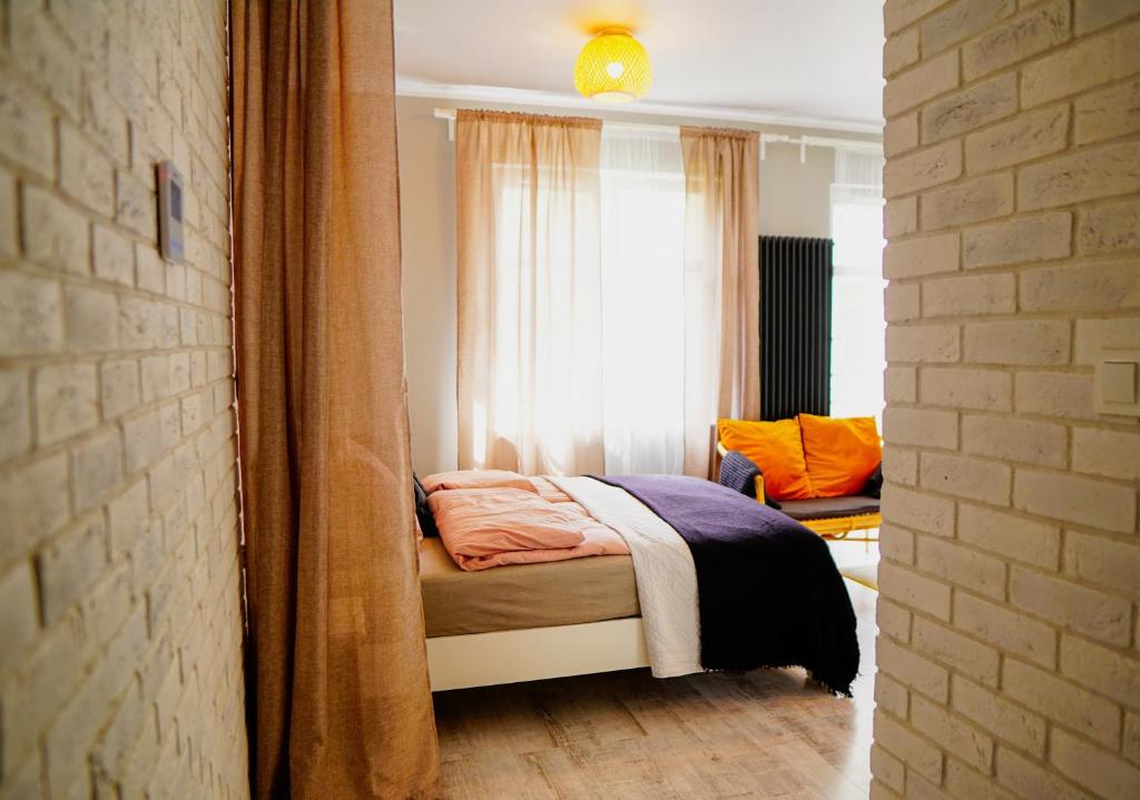a bedroom with a bed in front of a window at Apartament Ohar Downtown in Elblag