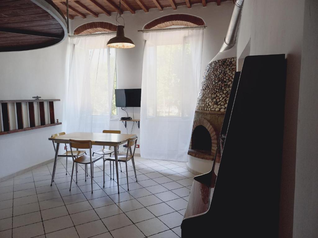 a living room with a table and a fireplace at Casina del porto in Livorno