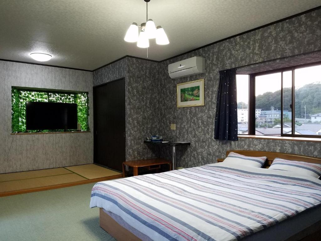 1 dormitorio con 1 cama grande y TV en Bibi Vacation Rental Only 2 groups per day Vacation STAY 5768, en Sakai
