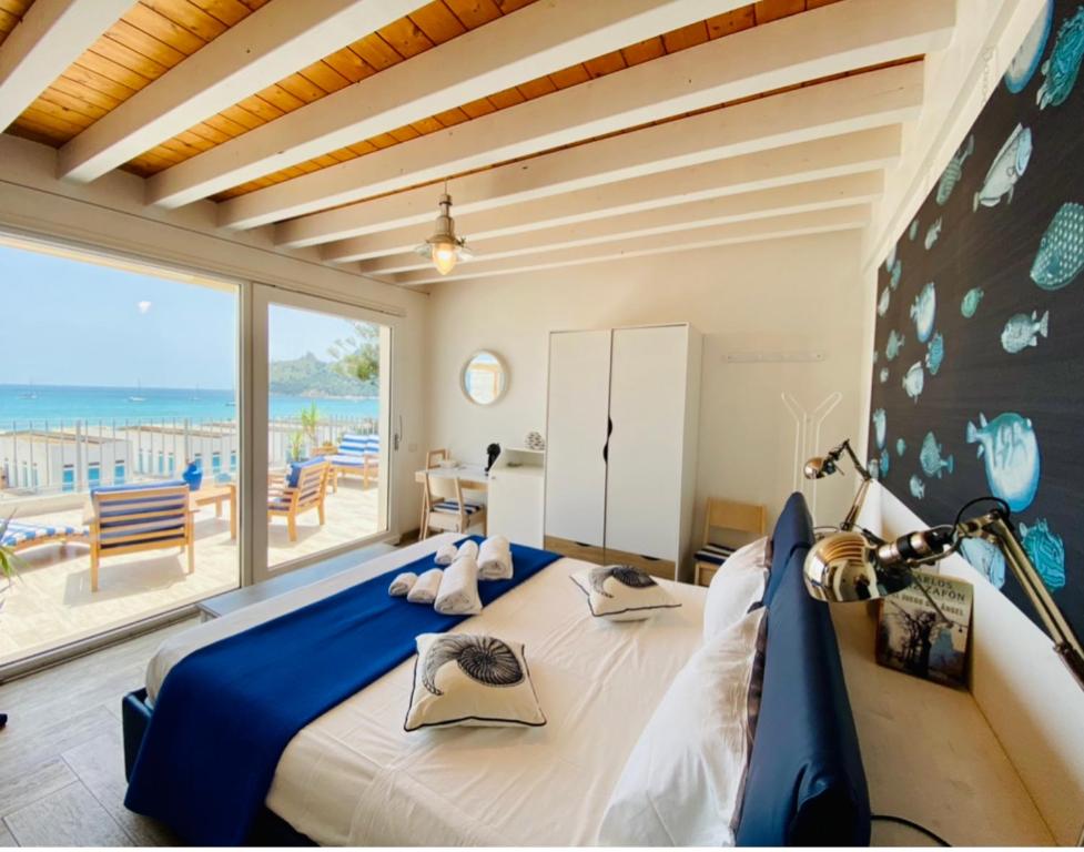 a bedroom with a large bed with a view of the ocean at Il Profumo del Mare in Cagliari