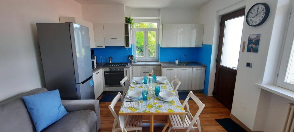 a kitchen with a table and chairs in a room at Casa Vacanze - Casa Quattro Luci in Tronzano Lago Maggiore