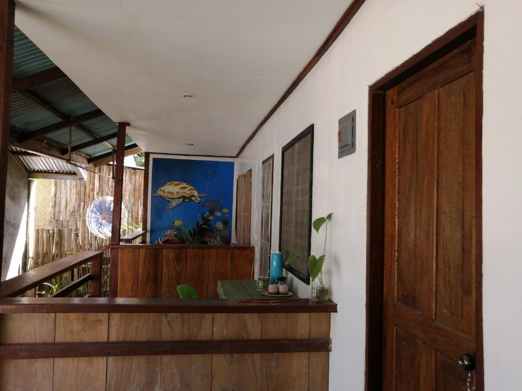 Habitación con escalera y puerta de madera. en Bundal Riverside Room#2 with Balcony or Terrace, en San Vicente