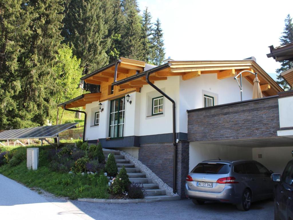a car parked in front of a house at Chalet Windbach in Saalbach-Hinterglemm