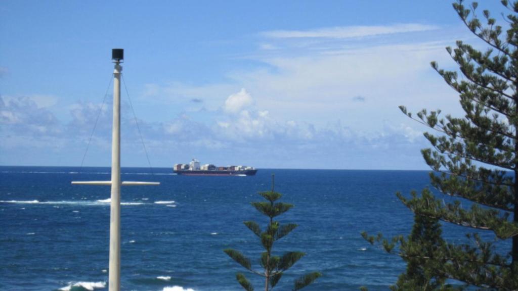 a cruise ship in the ocean with a pole at Unit 10 Sea Eagles Apartments in Caloundra