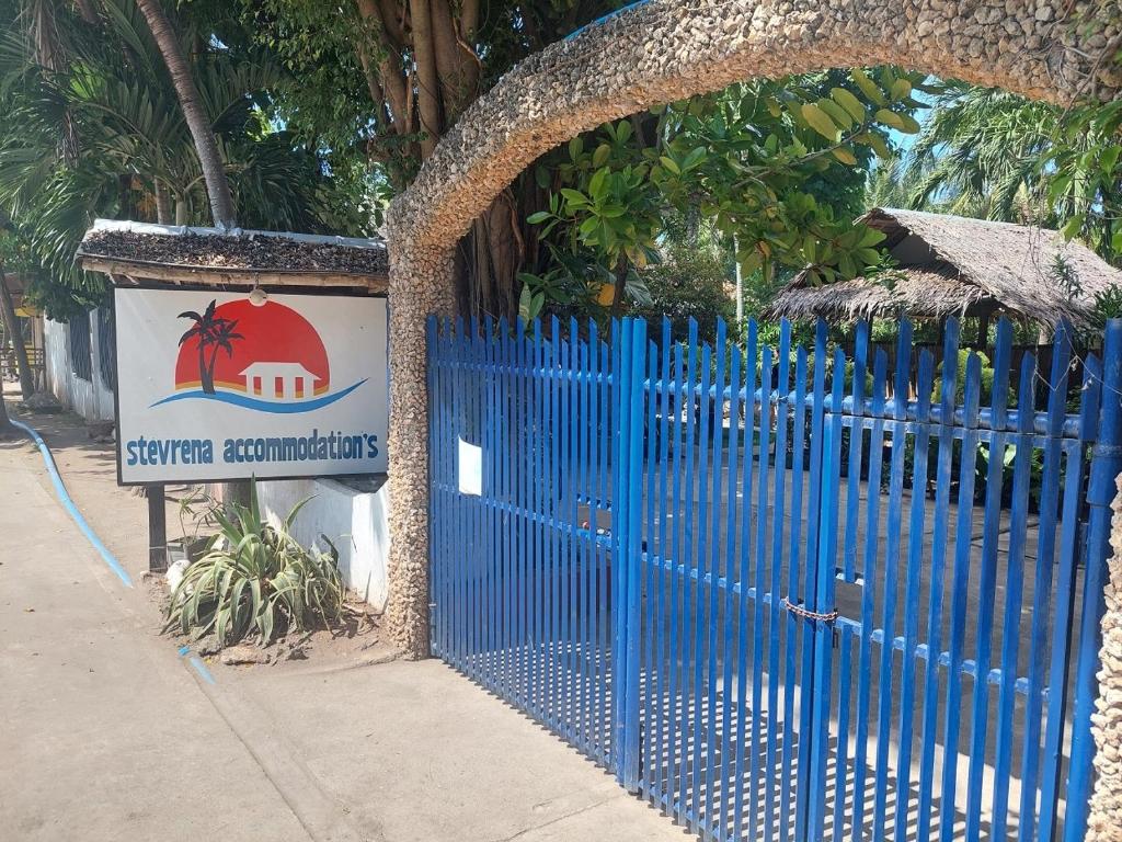 a blue gate with a sign for a resort at Stevrena Accommodations in Bantayan Island