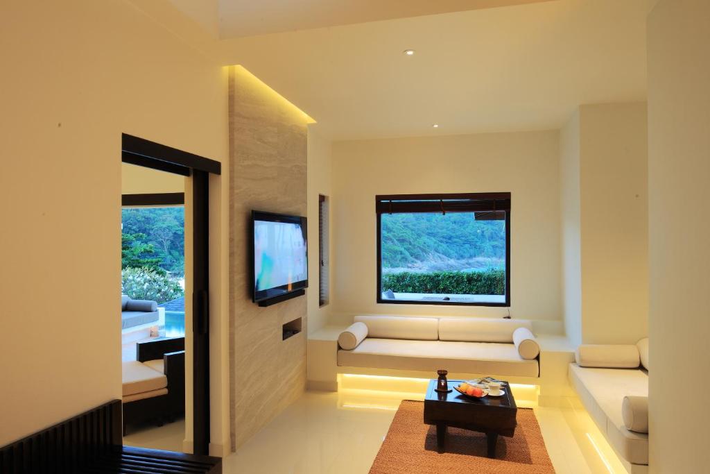 a living room with a couch and a window at The Racha in Ko Racha Yai 