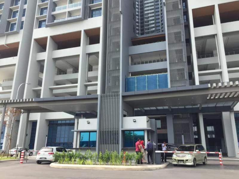 a group of people standing outside of a building at Atlantis Residences Malacca City by Nestcove in Malacca
